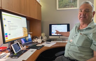 Instructor in front of several computer screens