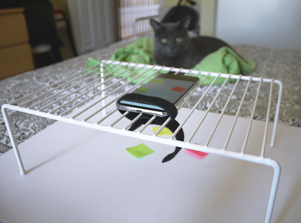 A kitchen wire shelf with a smartphone placed on it in order to create a document camera