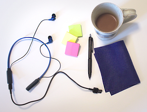 Coffee, headphones and other teaching supplies on a table